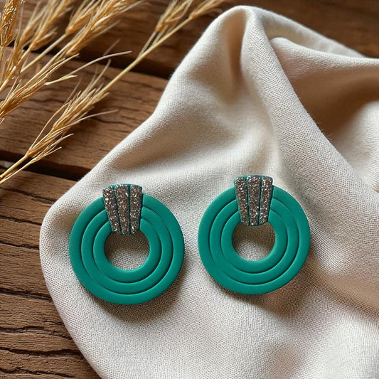 Boucles d’oreilles artisanales en pâte polymère vert Jade, ornées de paillettes Champagne.